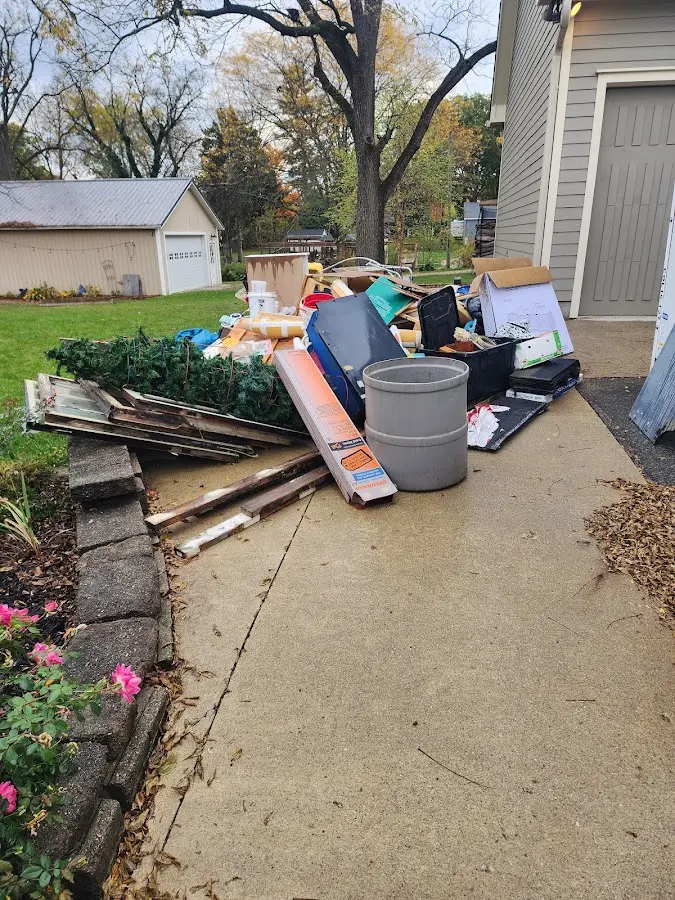 Dumpster being loaded with debris for Estate Cleanout Dumpster Rental in Massanetta Springs